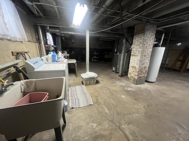 basement featuring heating unit, washer and clothes dryer, gas water heater, and sink