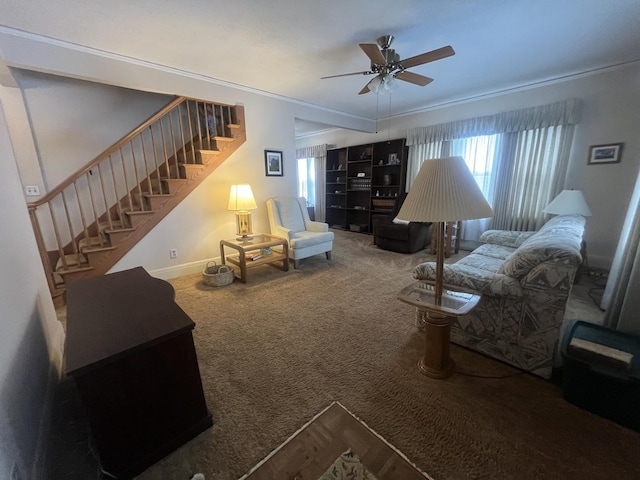 living room featuring carpet flooring, ceiling fan, and crown molding