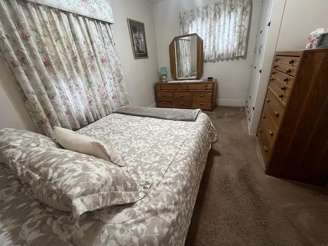 bedroom featuring dark colored carpet