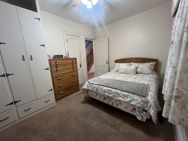 carpeted bedroom with ceiling fan and a closet