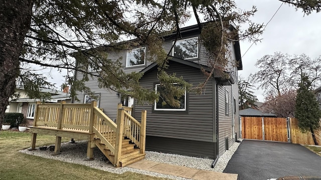 rear view of house featuring a deck