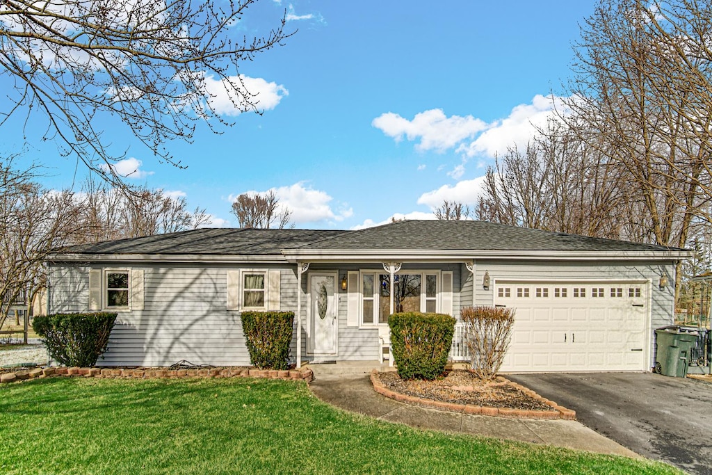 ranch-style home featuring a garage and a front yard