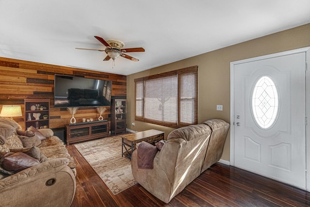 living room featuring wood walls, dark hardwood / wood-style flooring, and ceiling fan