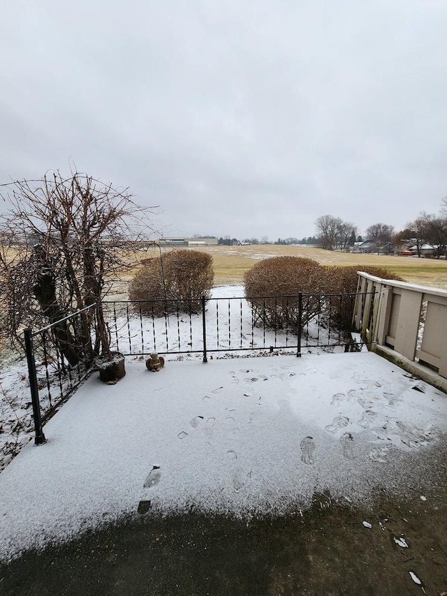 snowy yard with a rural view