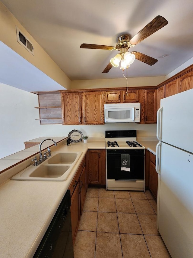 kitchen with ceiling fan, white appliances, sink, and light tile patterned floors