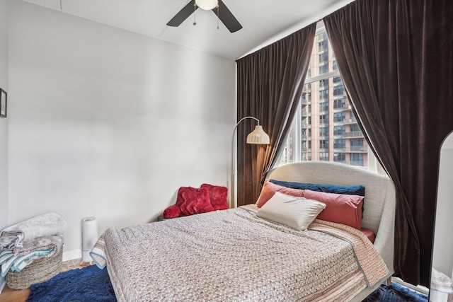 bedroom with multiple windows and ceiling fan