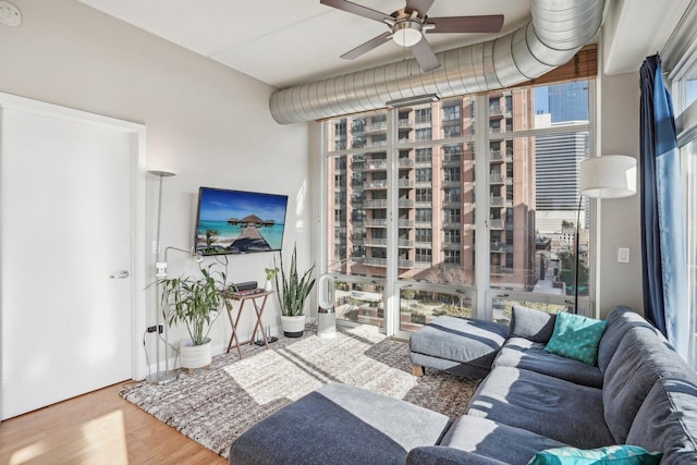 living room featuring ceiling fan and wood-type flooring