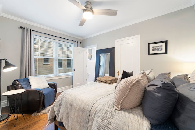 bedroom with ceiling fan, wood-type flooring, and ornamental molding