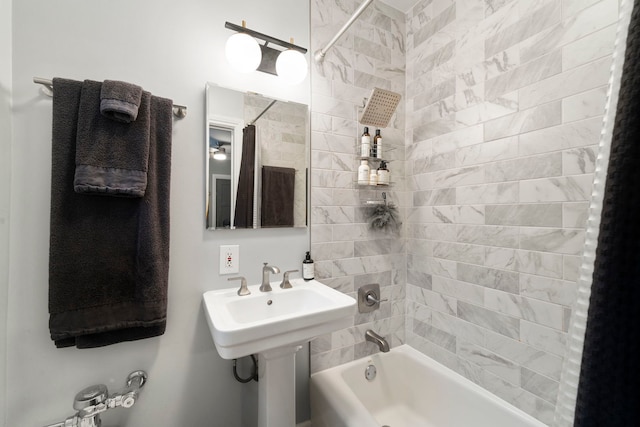 bathroom featuring tiled shower / bath and sink