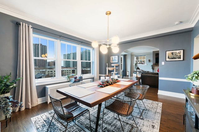 dining area featuring dark hardwood / wood-style floors and ornamental molding