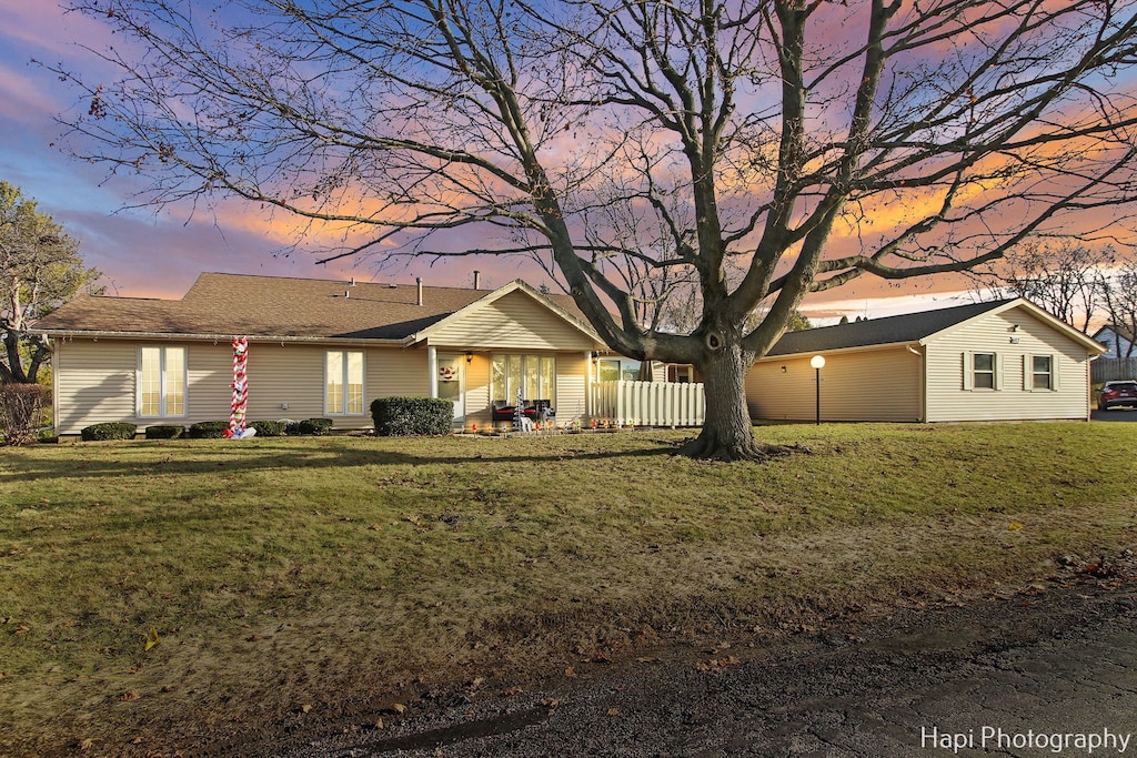 ranch-style house featuring a lawn