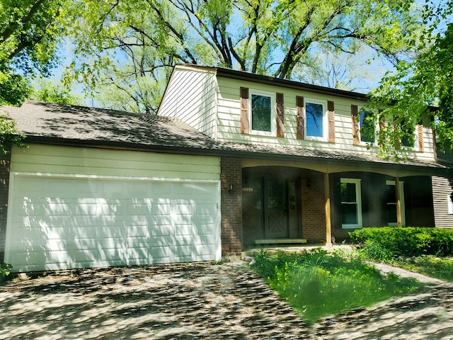 6111 Pingree Rd, Crystal Lake, IL 60014 - view of front of property with a garage, brick siding, a porch, and asphalt driveway