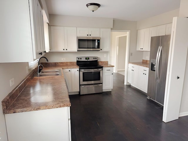 6111 Pingree Rd, Crystal Lake, IL 60014 - kitchen featuring appliances with stainless steel finishes, a sink, dark wood-style flooring, and white cabinetry
