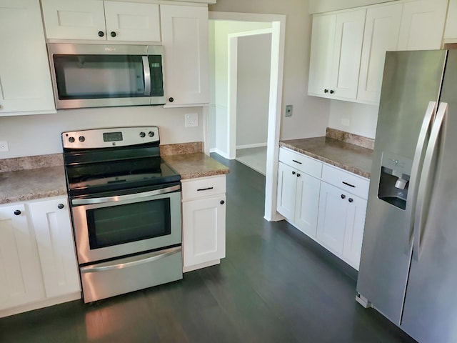 6111 Pingree Rd, Crystal Lake, IL 60014 - kitchen with appliances with stainless steel finishes, white cabinetry, and dark wood-style floors
