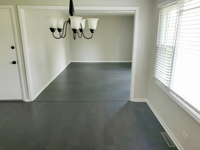 6111 Pingree Rd, Crystal Lake, IL 60014 - unfurnished dining area with healthy amount of natural light, a chandelier, baseboards, and dark wood-style floors