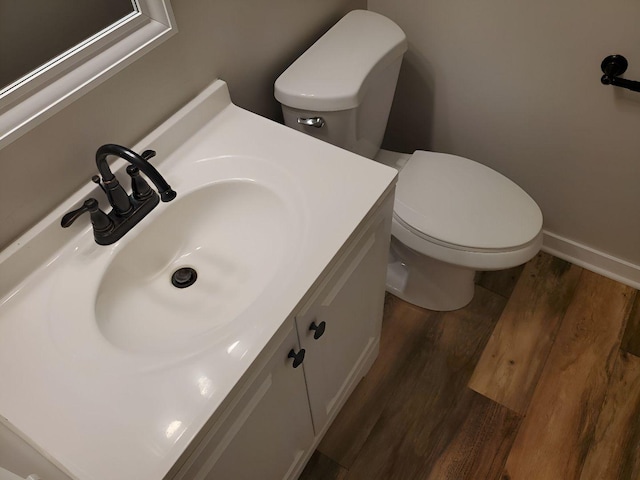 6111 Pingree Rd, Crystal Lake, IL 60014 - half bath with toilet, wood finished floors, vanity, and baseboards