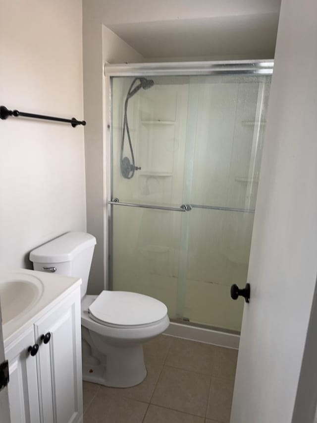 6111 Pingree Rd, Crystal Lake, IL 60014 - bathroom with tile patterned floors, a shower stall, vanity, and toilet