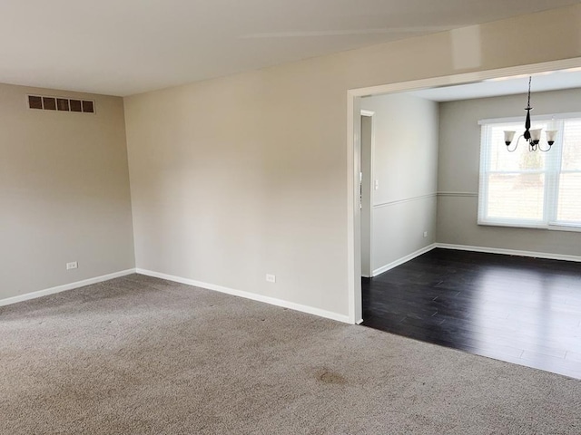 6111 Pingree Rd, Crystal Lake, IL 60014 - spare room featuring dark colored carpet, a chandelier, and baseboards