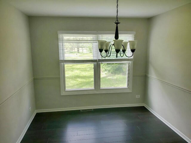 6111 Pingree Rd, Crystal Lake, IL 60014 - unfurnished dining area featuring a chandelier, dark wood-type flooring, and baseboards
