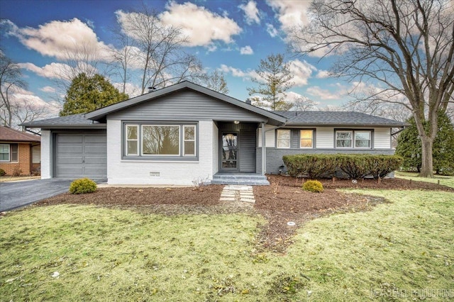 ranch-style home with a garage and a front lawn