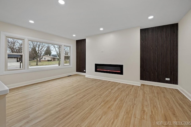 unfurnished living room featuring light wood-type flooring