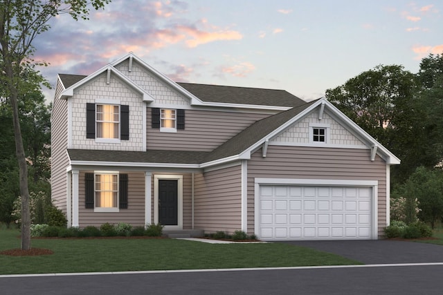 view of front facade with a lawn and a garage