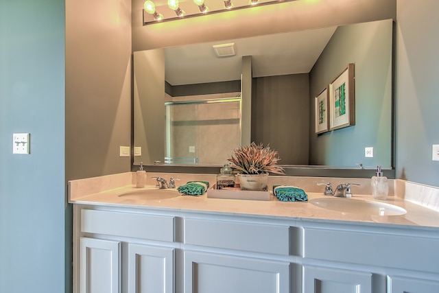 bathroom featuring vanity and a shower with door