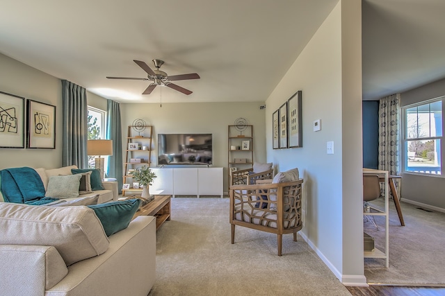 carpeted living room featuring ceiling fan and plenty of natural light