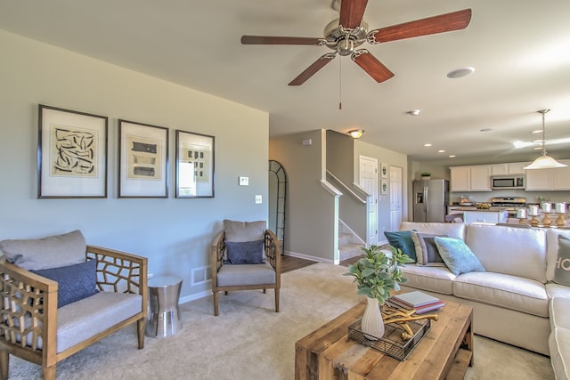 living room with ceiling fan and light carpet