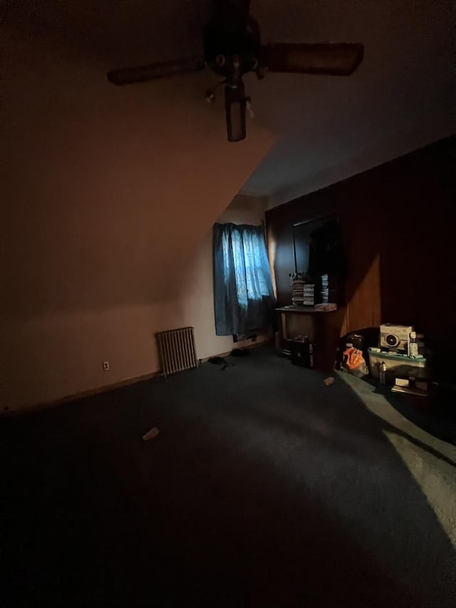 bonus room with carpet flooring and ceiling fan