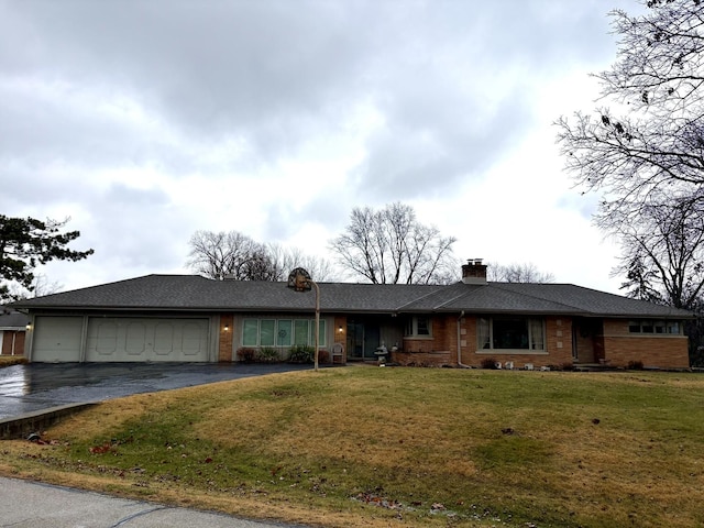 single story home featuring a front yard and a garage