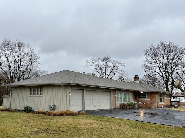 view of side of home featuring a garage and a lawn