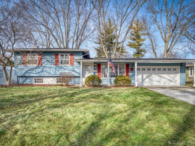 tri-level home featuring a garage and a front lawn