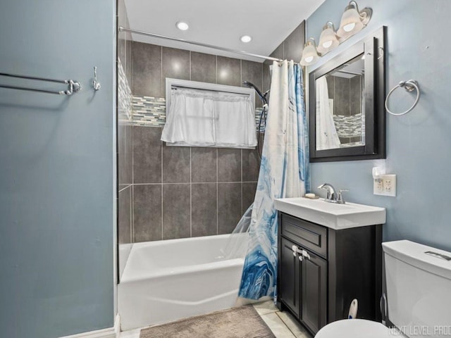 full bathroom featuring shower / bath combination with curtain, vanity, and toilet