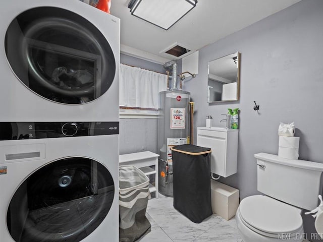 clothes washing area with stacked washer / drying machine and water heater