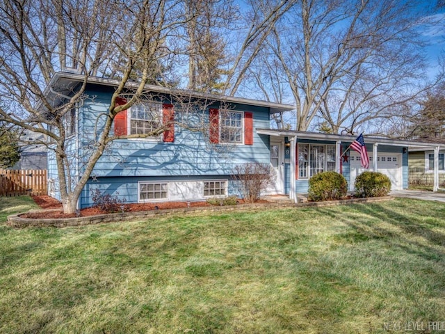 tri-level home with a garage and a front yard