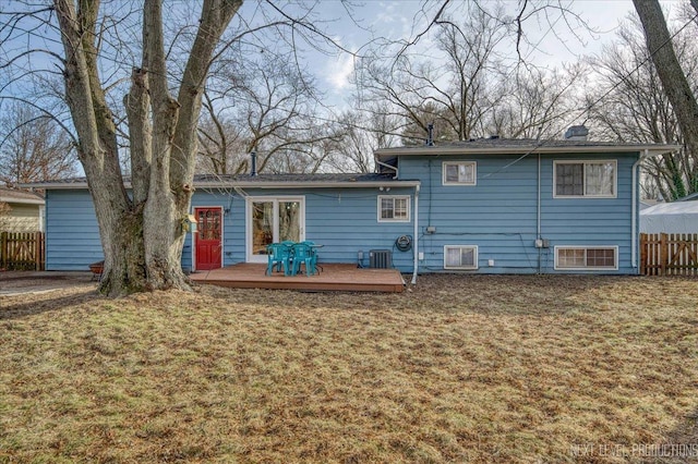 rear view of house with a wooden deck, a yard, and central AC unit