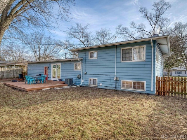 rear view of house featuring central AC, a yard, and a deck