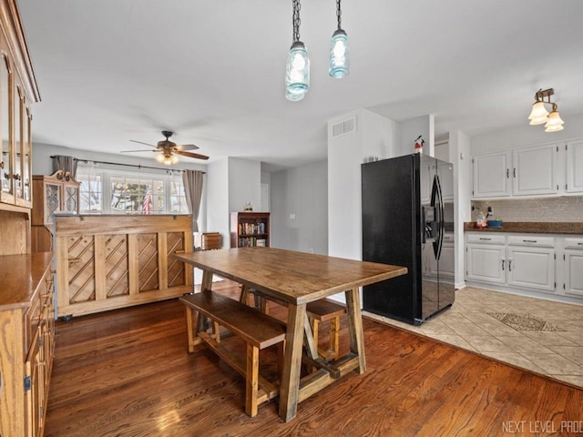 kitchen featuring decorative backsplash, stainless steel appliances, sink, light tile patterned floors, and white cabinetry