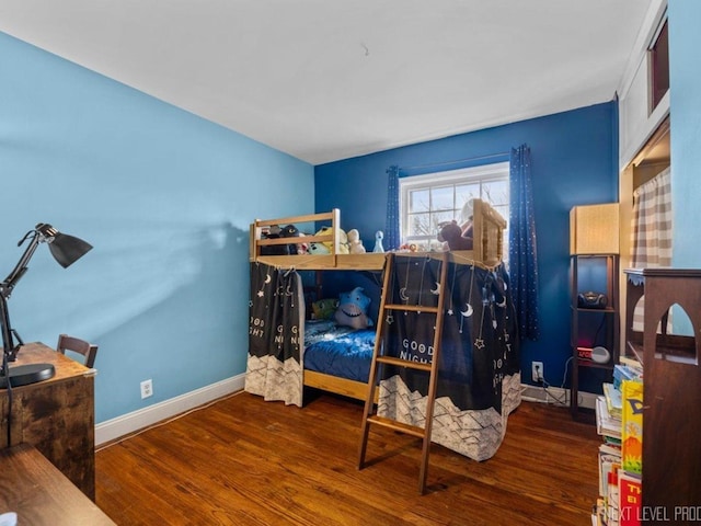 bedroom with dark hardwood / wood-style floors