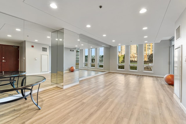 workout area with light wood-type flooring