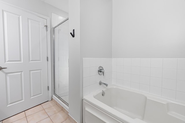 bathroom featuring tile patterned floors and shower with separate bathtub