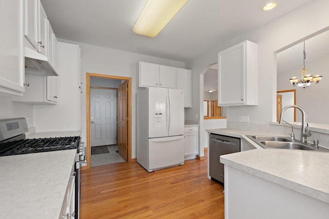 kitchen featuring stainless steel dishwasher, gas range oven, sink, decorative light fixtures, and white fridge with ice dispenser