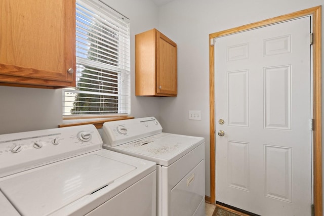 washroom featuring cabinets, washer and dryer, and a healthy amount of sunlight