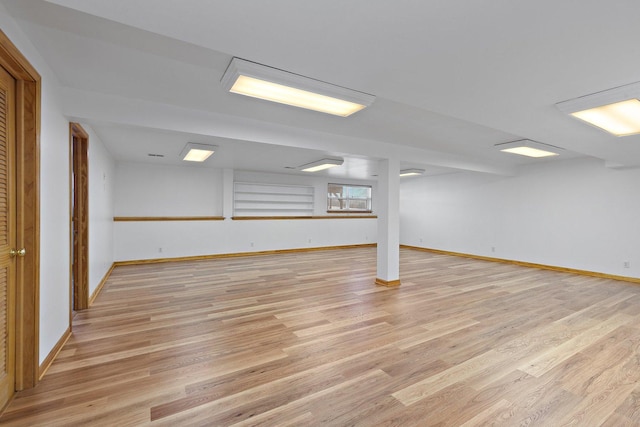 basement with light hardwood / wood-style flooring