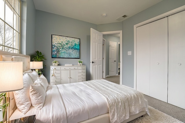 carpeted bedroom featuring a closet