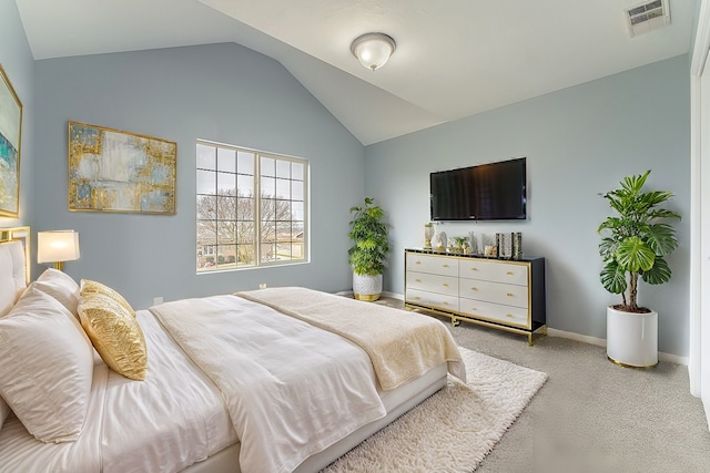 carpeted bedroom with vaulted ceiling