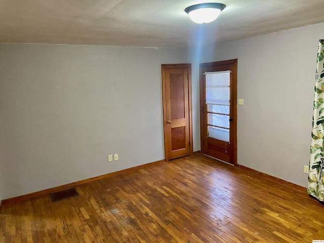 empty room featuring dark hardwood / wood-style flooring