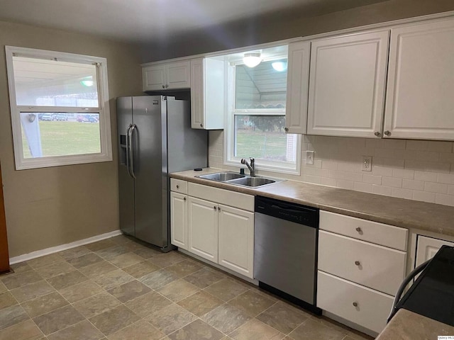 kitchen featuring white cabinetry, sink, tasteful backsplash, and appliances with stainless steel finishes