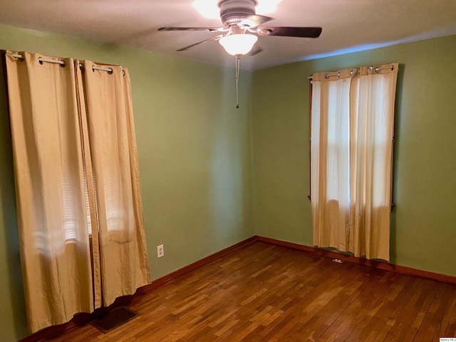 unfurnished room with hardwood / wood-style flooring and ceiling fan